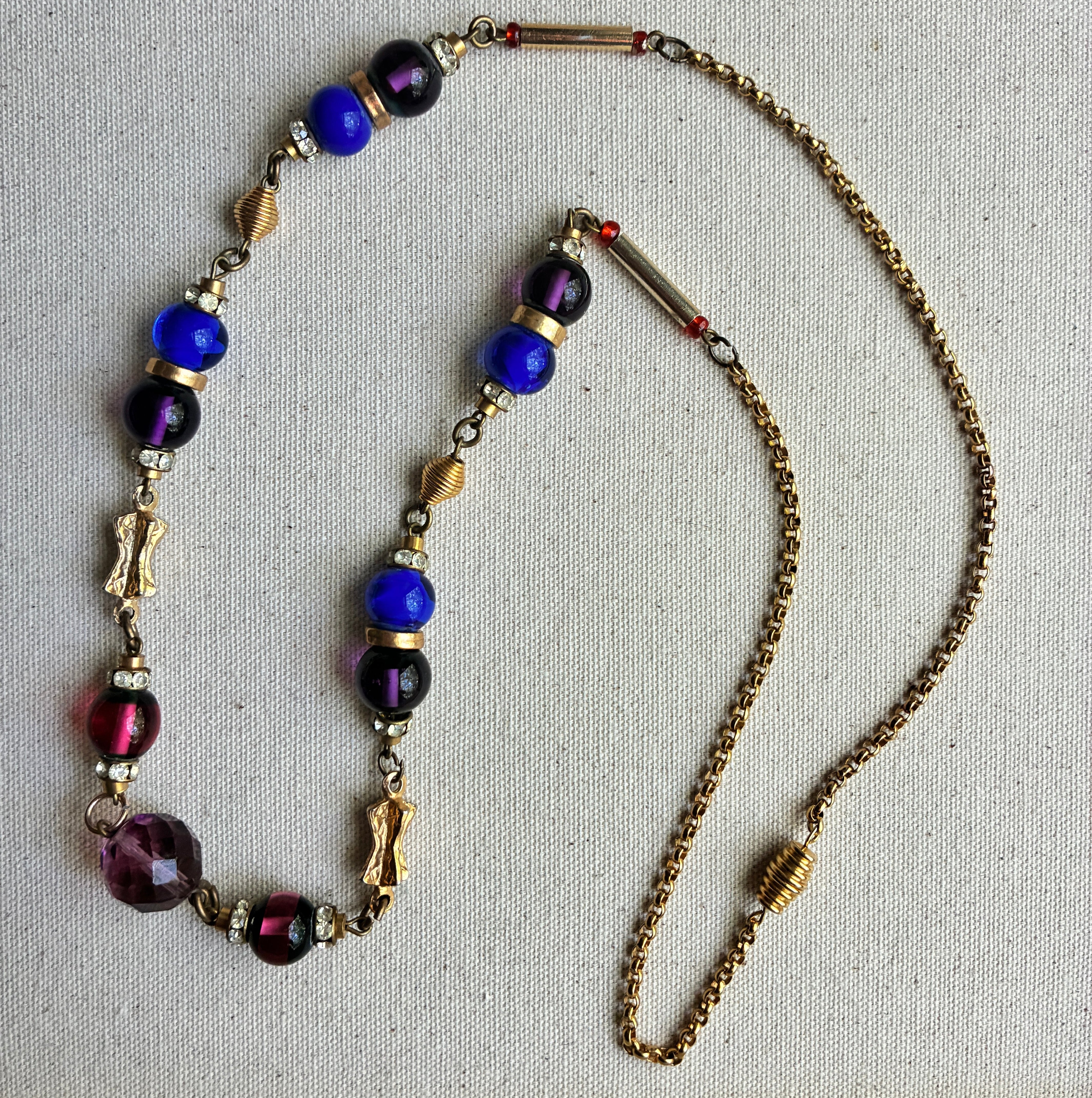 Necklace with multicolored beads on a textured gray background