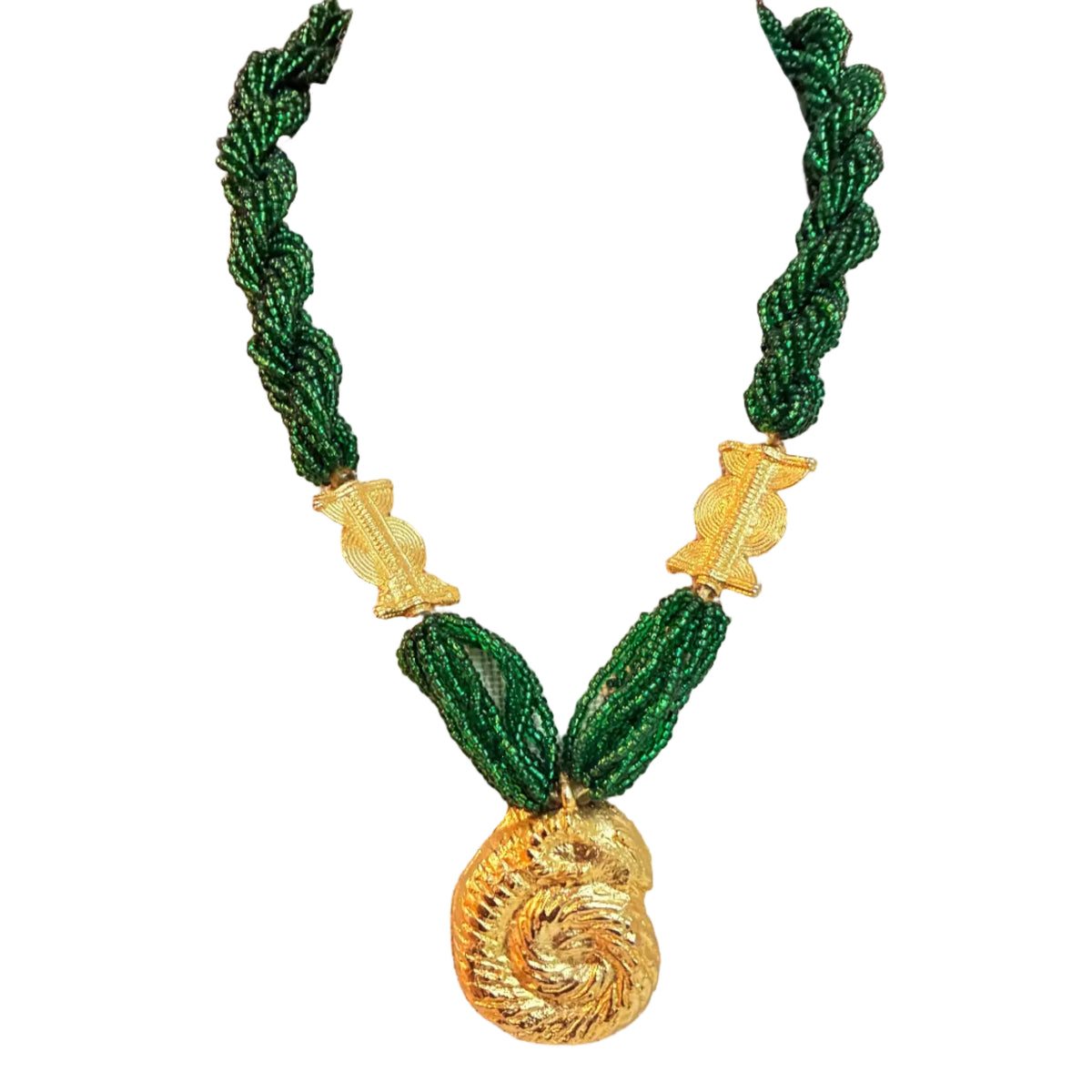 A beaded necklace with a large gold spiral pendant, displayed on a beige fabric mannequin bust. The necklace features dark green seed beads woven into braided and draped strands, accented with textured gold spacer beads.