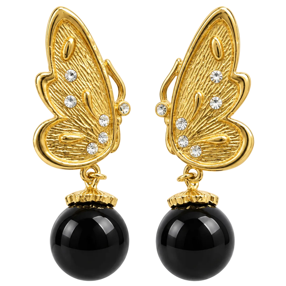 A pair of gold butterfly-shaped drop earrings with clear rhinestones and large black oval beads hanging below, shown on a plain white background.
