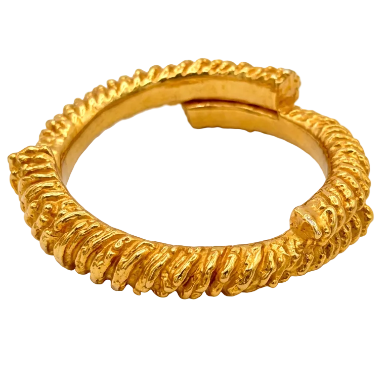 A textured gold ring with a twisted, rope-like band and an open adjustable clasp, shown on a plain white background.