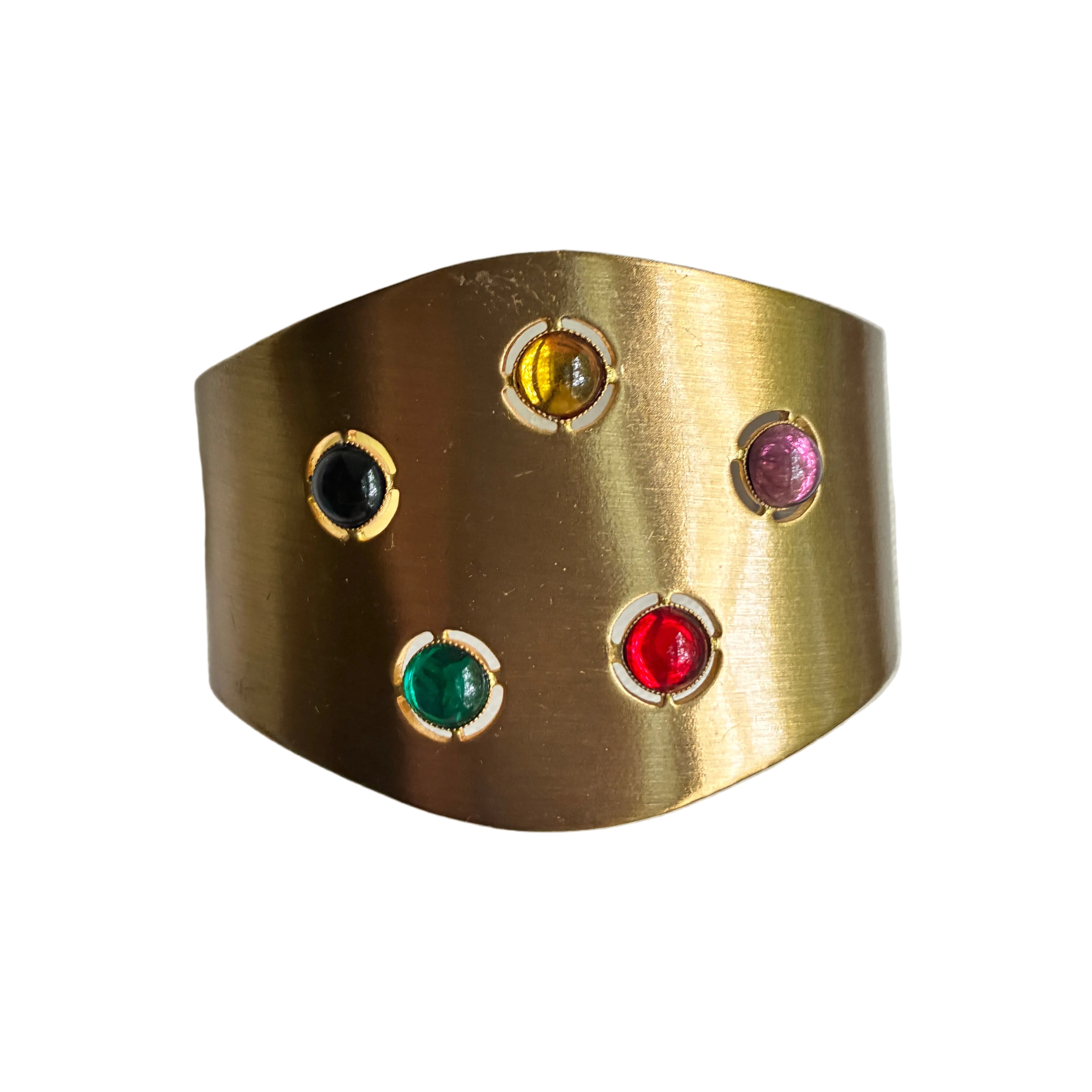 Gold cuff with colorful glass  on a light gray background