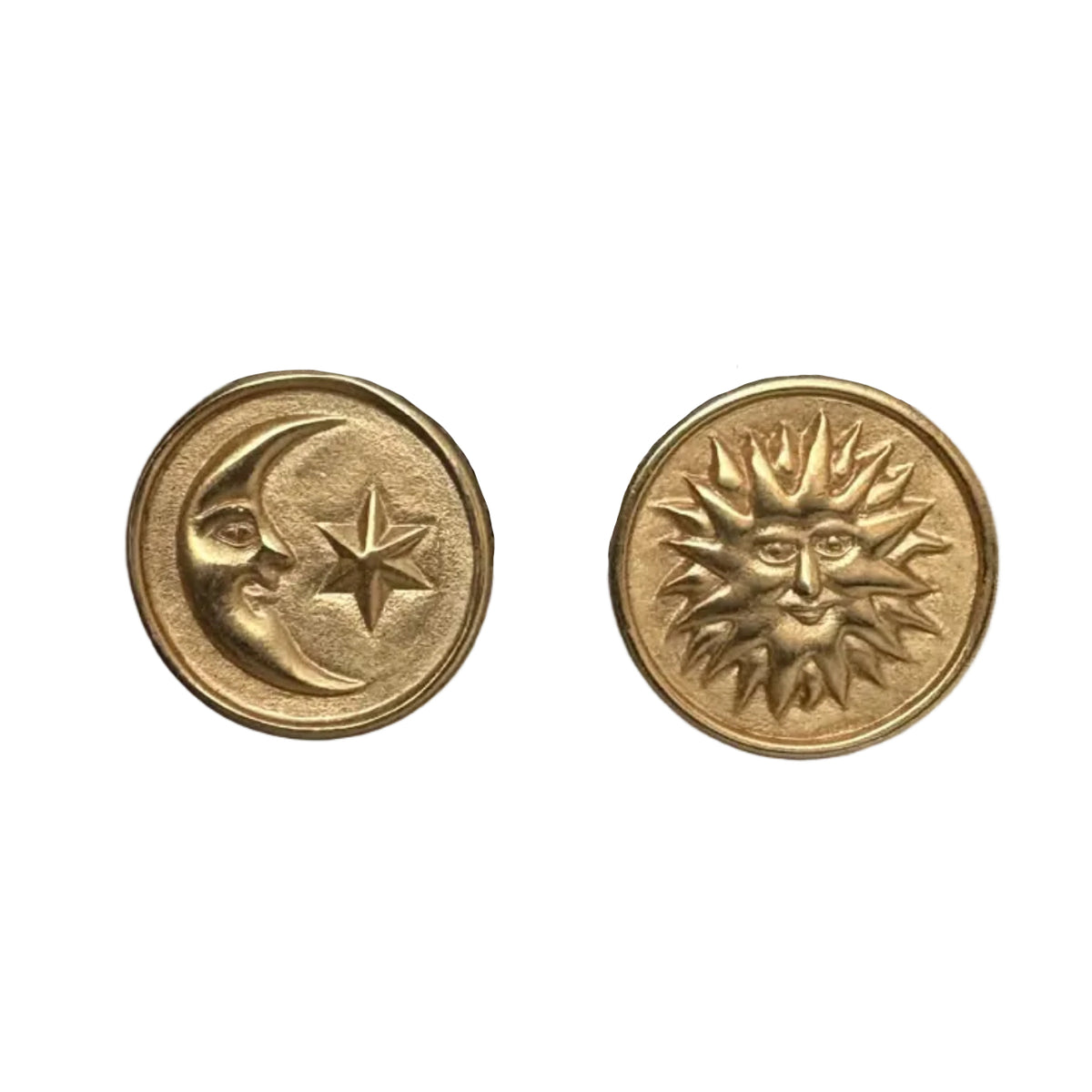 Two round gold-toned earrings shown side by side on a plain white background. The left piece features a crescent moon and star motif, and the right piece features a sun face with rays.