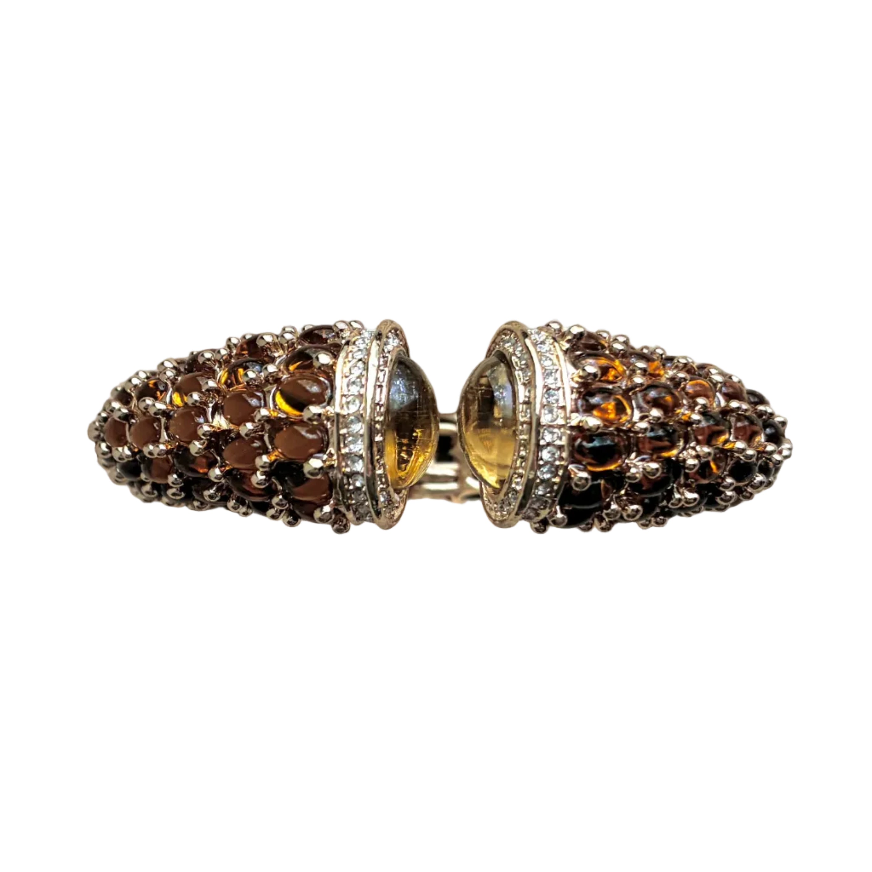 a modern amber crystal bracelet, 9" around 2.25" diameter, hinge opening