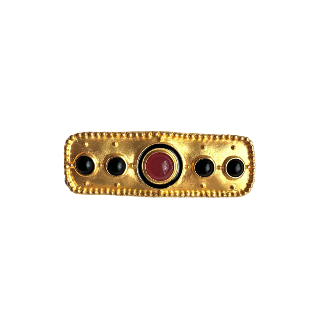 A vintage gold-toned bar brooch featuring a central round red cabochon stone surrounded by four smaller black onyx-like round stones